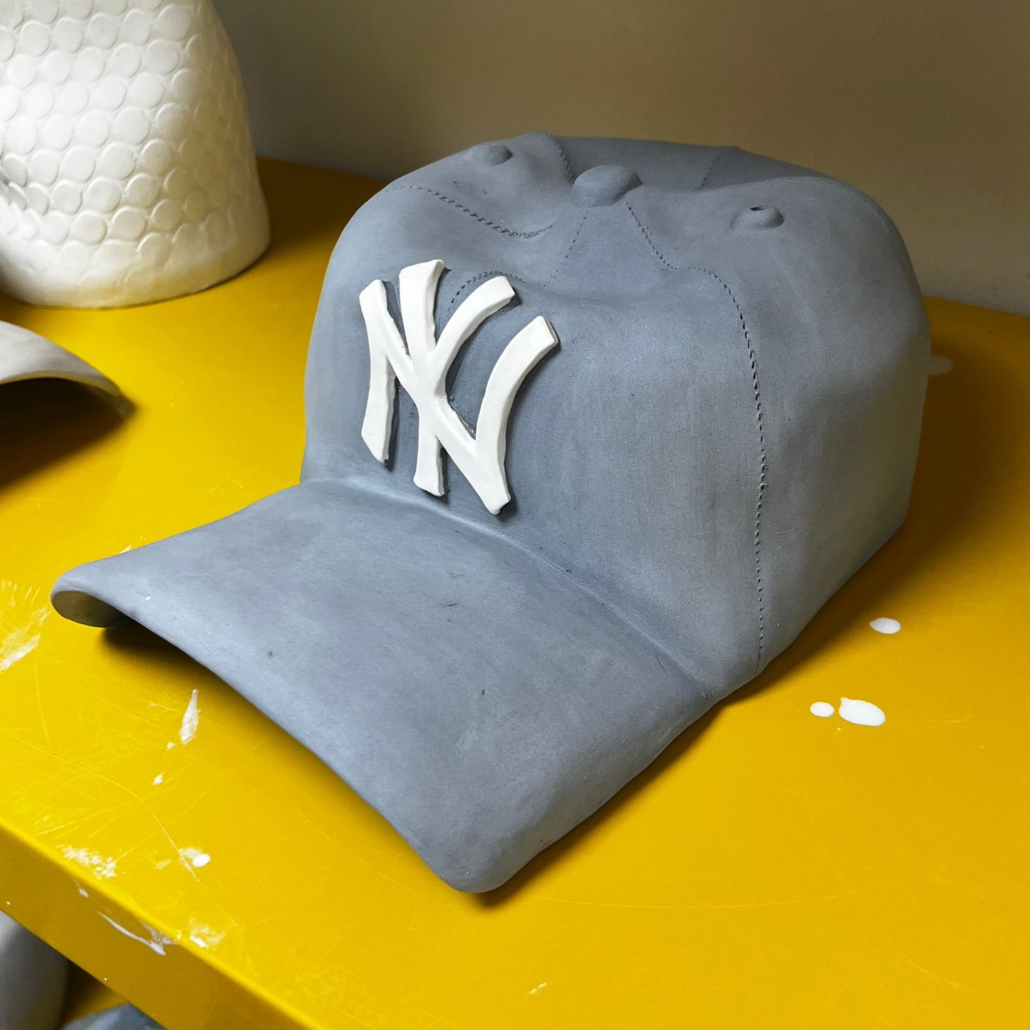 NY Yankees Ceramic Cap Sculpture (Grey) - Figurative Sculpture